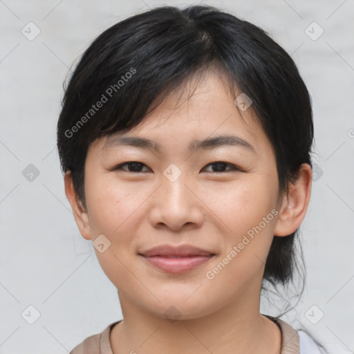 Joyful asian young-adult female with medium  brown hair and brown eyes