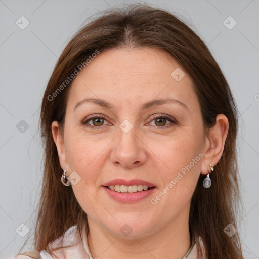 Joyful white adult female with long  brown hair and grey eyes