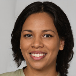 Joyful latino young-adult female with medium  brown hair and brown eyes