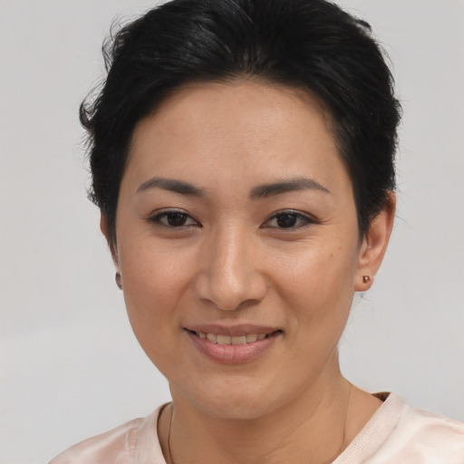 Joyful asian young-adult female with short  brown hair and brown eyes