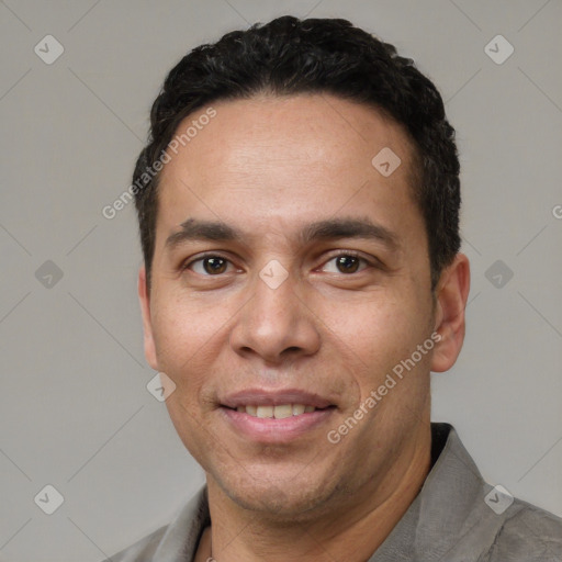 Joyful white adult male with short  black hair and brown eyes