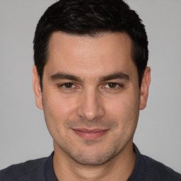 Joyful white adult male with short  brown hair and brown eyes