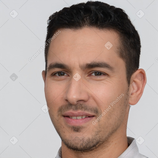 Joyful white young-adult male with short  black hair and brown eyes