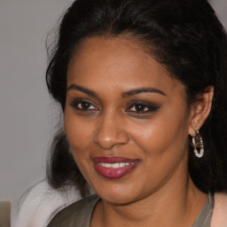 Joyful black young-adult female with medium  brown hair and brown eyes