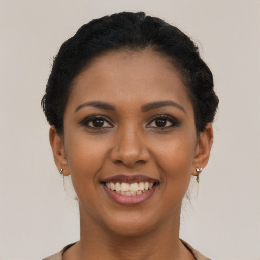 Joyful latino young-adult female with short  brown hair and brown eyes