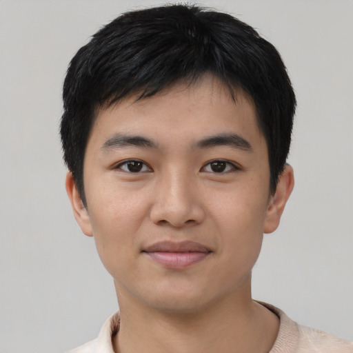 Joyful asian young-adult male with short  black hair and brown eyes