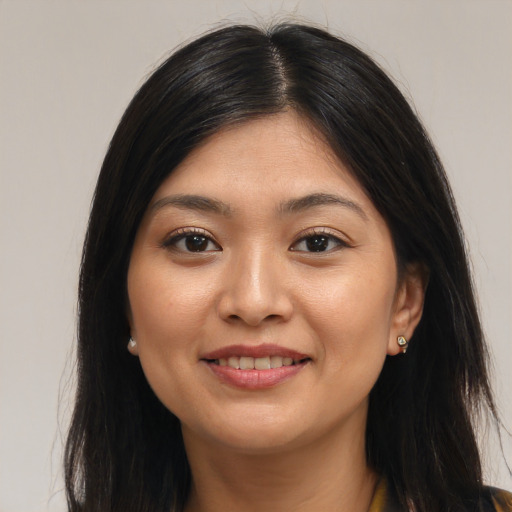 Joyful asian young-adult female with long  brown hair and brown eyes