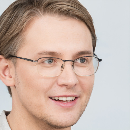 Joyful white adult male with short  brown hair and blue eyes