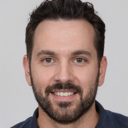 Joyful white adult male with short  brown hair and brown eyes