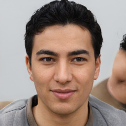 Joyful asian young-adult male with short  brown hair and brown eyes