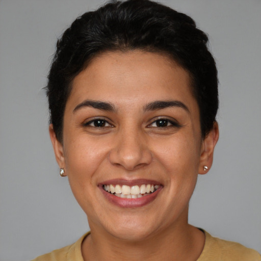 Joyful latino young-adult female with short  brown hair and brown eyes