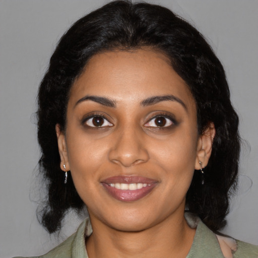 Joyful black young-adult female with medium  black hair and brown eyes