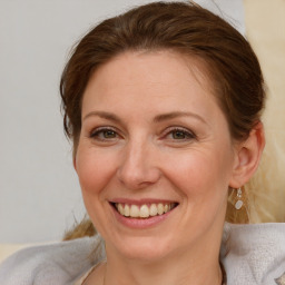 Joyful white adult female with medium  brown hair and brown eyes