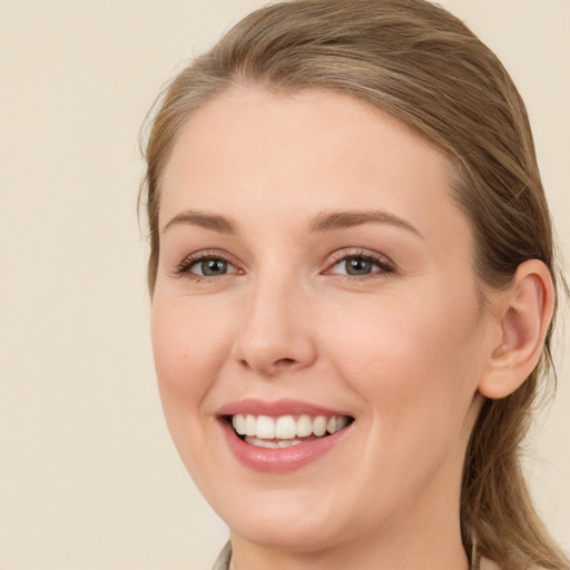 Joyful white young-adult female with long  brown hair and grey eyes