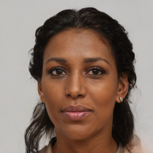 Neutral black adult female with medium  black hair and brown eyes