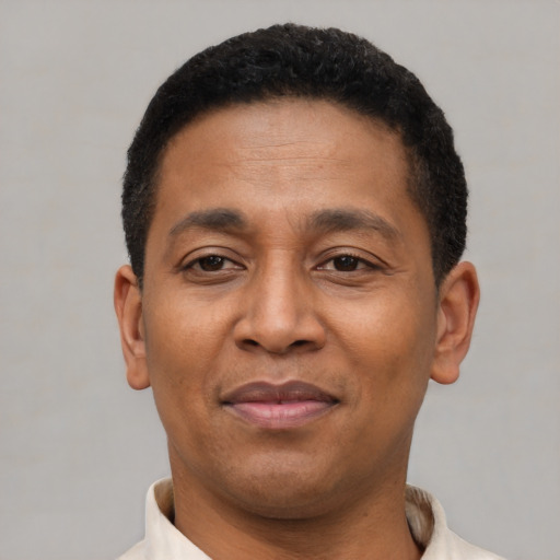 Joyful latino young-adult male with short  brown hair and brown eyes
