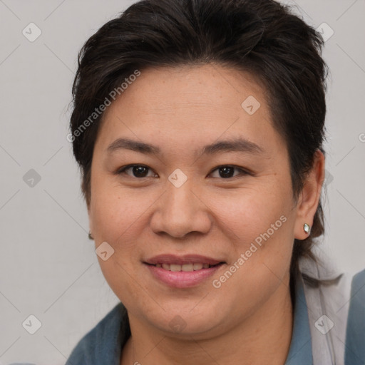 Joyful asian adult female with medium  brown hair and brown eyes