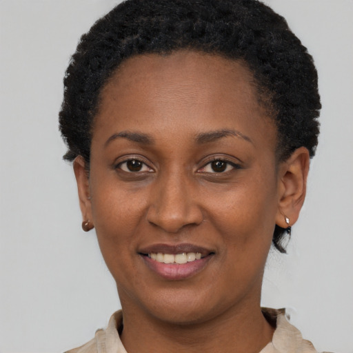 Joyful black young-adult female with short  brown hair and brown eyes
