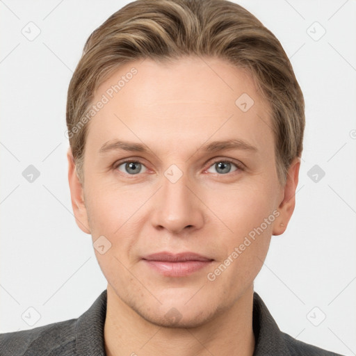 Joyful white young-adult male with short  brown hair and grey eyes