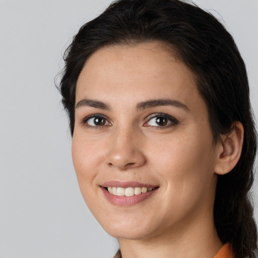 Joyful white young-adult female with long  brown hair and brown eyes