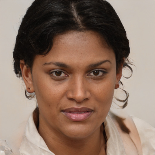 Joyful black young-adult female with medium  brown hair and brown eyes