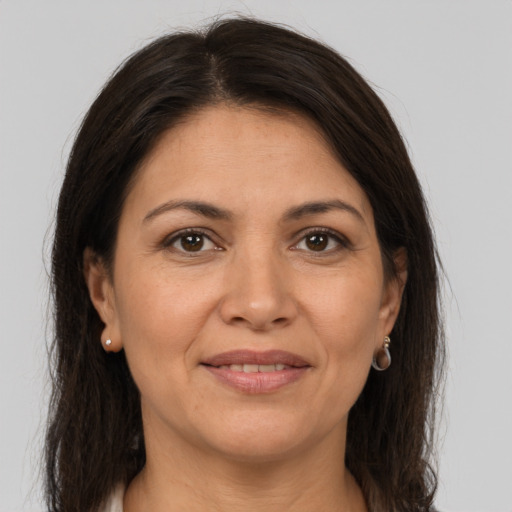 Joyful white adult female with long  brown hair and brown eyes