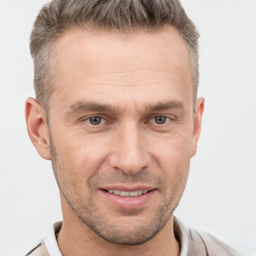 Joyful white adult male with short  brown hair and brown eyes