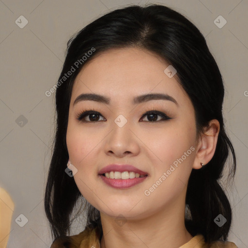 Joyful asian young-adult female with long  black hair and brown eyes