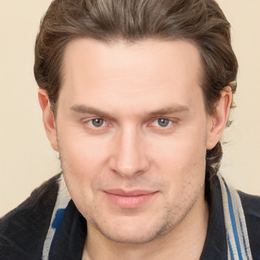 Joyful white adult male with short  brown hair and brown eyes