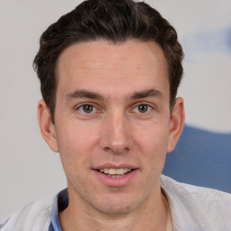 Joyful white adult male with short  brown hair and brown eyes