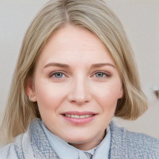 Joyful white young-adult female with medium  brown hair and blue eyes