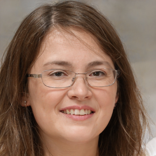 Joyful white adult female with long  brown hair and brown eyes