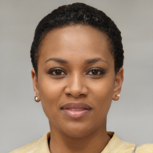 Joyful black young-adult female with short  brown hair and brown eyes
