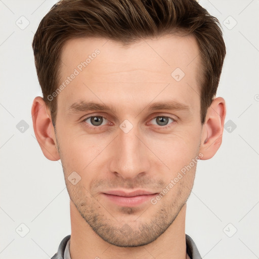 Joyful white young-adult male with short  brown hair and grey eyes