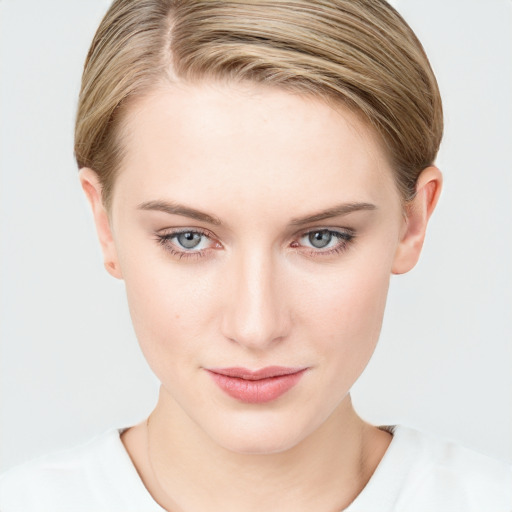 Joyful white young-adult female with short  brown hair and blue eyes