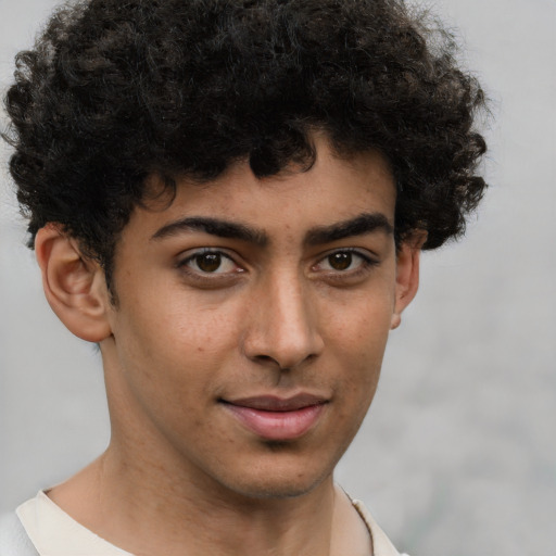 Joyful latino young-adult male with short  brown hair and brown eyes