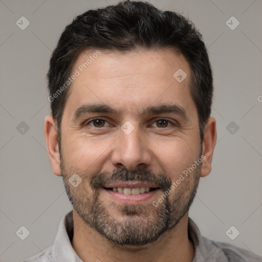 Joyful white adult male with short  black hair and brown eyes