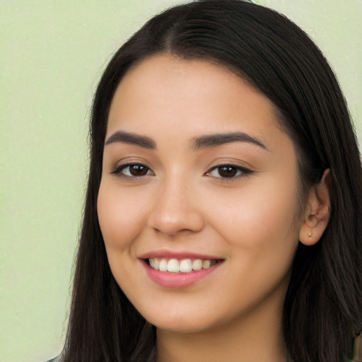 Joyful latino young-adult female with long  black hair and brown eyes