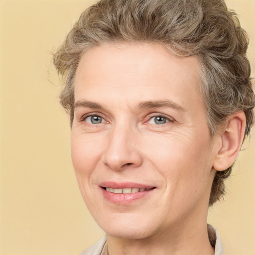 Joyful white adult female with medium  brown hair and grey eyes