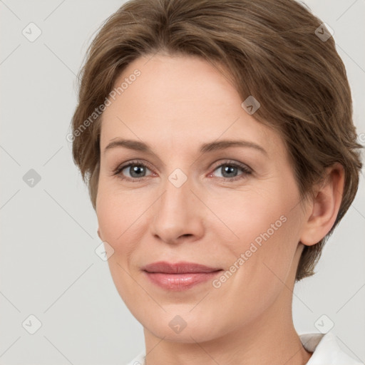 Joyful white adult female with short  brown hair and grey eyes