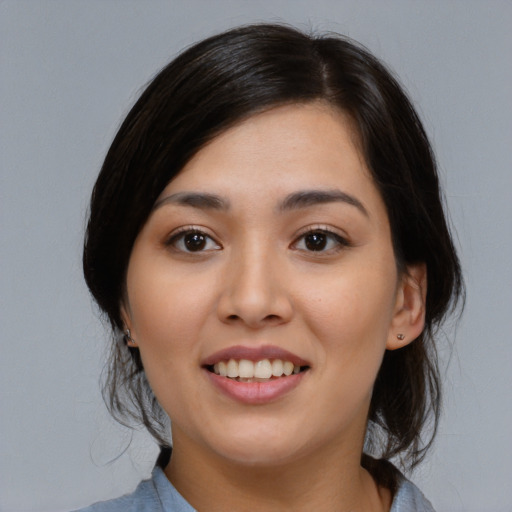 Joyful white young-adult female with medium  black hair and brown eyes