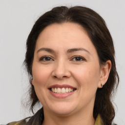 Joyful white adult female with medium  brown hair and brown eyes