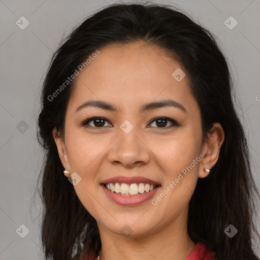 Joyful latino young-adult female with long  brown hair and brown eyes