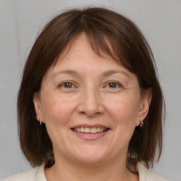 Joyful white adult female with medium  brown hair and brown eyes