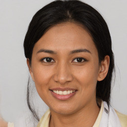 Joyful latino young-adult female with medium  brown hair and brown eyes