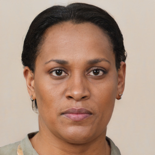 Joyful latino adult female with short  brown hair and brown eyes