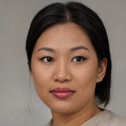 Joyful asian young-adult female with medium  brown hair and brown eyes