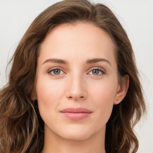 Joyful white young-adult female with long  brown hair and green eyes