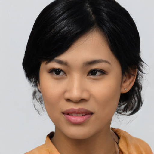 Joyful asian young-adult female with medium  black hair and brown eyes