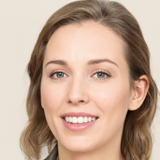 Joyful white young-adult female with medium  brown hair and green eyes